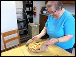  Sister Gretchen shows off the pie she baked when a Blade reporter visited.