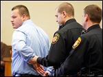  Joshua Waxler is handcuffed after being sentenced by Judge Myron Duhart in Lucas County Common Pleas Court. Waxler had entered an Alford plea to one count of endangering children.