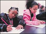  Amaree Slaughter, left, and Yelena Castillo write stories as part of the Farmhouse at Wildwood Metropark in Toledo as part of the Women's Initiative.
