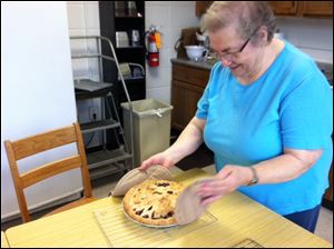 Sister Gretchen shows off the pie she baked when a Blade reporter visited.