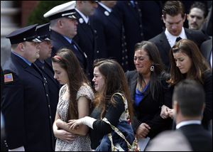 Mourners leave the funeral for Boston Marathon bomb victim Krystle Campbell today in Medford, Mass..