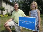  Dan Greenberg and his daughter Nina are besides an Obama/Biden yard sign displayed outside of their home last July, nearly four months prior to the presidential election.