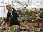  Shelly Derkin, of Maumee, browsed the plant selection Wednesday at Owens' annual Spring Plant Sale.