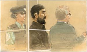 In this courtroom sketch, Raed Jaser appears in court in Toronto on Tuesday. Jaser, 35, and Chehib Esseghaier, 30, were arrested and charged Monday in what the RCMP said was the first known al-Qaeda terror plot in Canada.