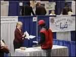  Kathie Maiello of Any-Time Home Care, left, talks with Jashod Chaney of Albany at the Dr. King Career Fair at the Empire State Plaza Convention Center, in Albany, N.Y.