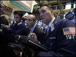  Trader James Denaro, center, and Jonathan Corpina, right, work on the floor of the New York Stock Exchange Wednesday.