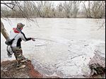  Andy Borton of Wauseon fishes the Maumee River at Side Cut Metropark in Maumee. Swift currents make wading treacherous; debris interferes near shore.