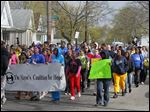  Toledo youth and adults alike, invited by the Toledo Youth Services Commission and the Coalition for Hope, march against violence down Elm Street near Noble.