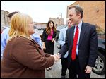  Pam Weirauch, owner of Pam’s Corner, greets Democratic gubernatorial candidate Ed FitzGerald at her restaurant in down-town Toledo, where he met with about 40 supporters Thursday.