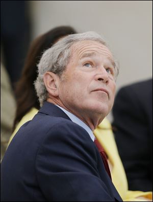 Former President George W. Bush participates in a signing ceremony for the joint use agreement between the National Archive and the George W. Bush Presidential Center.