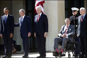 President Barack Obama stands with, from second from left, former Presidents George W. Bush, Bill Clinton, George H.W. Bush, and Jimmy Carter at the dedication today of the George W. Bush presidential library on the campus of Southern Methodist University in Dallas.