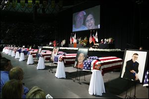 Casket sit in front of the stage of a memorial for firefighters who were killed in the West, Texas, fertilizer plant explosion prior to President Obama's arrival, Thursday, at Baylor University.