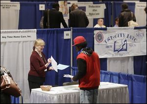Kathie Maiello of Any-Time Home Care, left, talks with Jashod Chaney of Albany at the Dr. King Career Fair at the Empire State Plaza Convention Center, in Albany, N.Y.