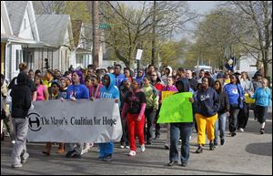 Toledo youth and adults alike, invited by the Toledo Youth Services Commission and the Coalition for Hope, march against violence down Elm Street near Noble.