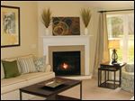  A vaulted ceiling and a gas fireplace with a granite surround make this great room an inviting space.