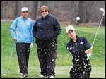  UT golfer Sathika Ruenreong, left, and coach Nicole Hollingsworth watch Manisa Isavas practice recently at the Toledo Country Club. Ruenreong fired a 77 and Isavas a 78 at Friday's MAC tournament.