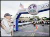  Tom Falvey holds a U.S. flag as the national anthem is played before the start of the 2012 Glass City Marathon.