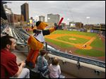  Muddy the Mud Hen cheers his team to the amusement of Dustin Macaulay, Toledo, and his children Alex Macaulay, 7, and Brooklyn Macaulay, 5, as the Toledo Mud Hens play the Columbus Clippers at Fifth Third Field.