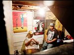  Aaron Belton, left, and his brother Christopher Belton sit in their basement recording studio where Christopher composes music for his group Flip Cash. 