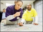  Gang members ‘Kid,’ left, and ‘Chaos,’ who are incarcerated at the Lucas County Correctional Treatment Facility on Jefferson Avenue, help create a Toledo gang-territories map for The Blade. The pair would only give their street names.