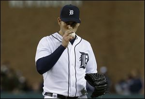 Detroit Tigers pitcher Anibal Sanchez kisses the ball after striking out Atlanta Braves' Reed Johnson in the eighth inning of a baseball game in Detroit, Friday April 26, 2013.  Sanchez struck out 17 in eight innings.