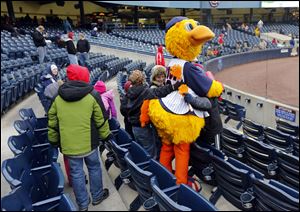 Muddy the Mud Hen is surrounded by fans as the Toledo Mud Hens play the Columbus Clippers at Fifth Third Field