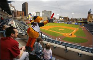 Muddy the Mud Hen cheers his team to the amusement of Dustin Macaulay, Toledo, and his children Alex Macaulay, 7, and Brooklyn Macaulay, 5, as the Toledo Mud Hens play the Columbus Clippers at Fifth Third Field.