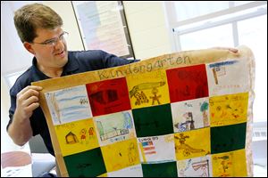 Principal Scott Best shows a quilt made by kindergartners at Fort Meigs Elementary. The quilt, which was themed for Fort Meigs, was one of the students' projects on display at the fort's museum.