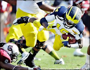 Michigan’s Denard Robinson was selected by Jacksonville in the fifth round on Saturday, the first Wolverine picked this year.