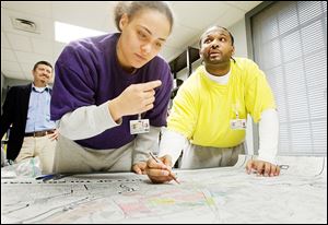 Gang members ‘Kid,’ left, and ‘Chaos,’ who are incarcerated at the Lucas County Correctional Treatment Facility on Jefferson Avenue, help create a Toledo gang-territories map for The Blade. The pair would only give their street names.