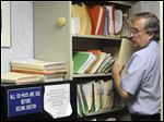  Ted Hole files papers, answers calls, makes appointments, and check in his patients among other duties. The 63-year old doctor has been in practice alone for 34 years.