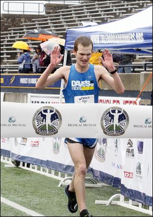 Evan Gaynor of Delta set a course record of 2 hours, 21 minutes, 20 seconds to win the men's title at the Medical Mutual Glass City Marathon.