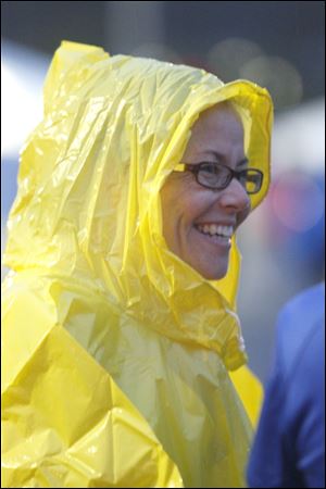 Carrie Zimmerman, from Bryan, Ohio, wears a yellow raincoat and a smile as she prepares to start the race. 