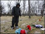  Mitchell Moore, an ex-gang member, stands at the grave site of his son Montrese Moore, a member of the Manor Boyz who died last year at the age of 19 in a shooting at the corner of Cherry and Bancroft streets.