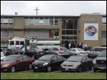  Police and firefighters gather outside LaSalle High School in Cincinnati after a high school student pulled out a gun and shot himself in a classroom. 