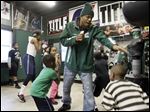 Roshawn Jones, center, owner of Soul City Boxing and Wrestling gym trains one of his pupils during a Monday night session.