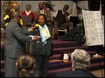  From left: Rev. Otis Gordon asks Paula Hicks-Hudson to adopt strategies during the annual Toledoans United for Social Action (TUSA) meeting at Friendship Baptist Church in Toledo.