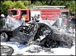  Firefighters in Syria extinguish a fire after a car bomb exploded, targeting Prime Minister Wael al-Halqi this week.