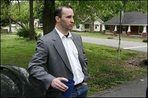 Everett Dutschke stands in the street near his home in Tupelo, Miss., and waits for the FBI to arrive and search his home last Tuesday.