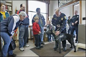 Woodville police Officer Steve Gilkerson introduces his new police dog, Raider, to 70 residents at the Woodville Public Library. Raider, a 14-month-old Dutch shepherd, came from Belgium and is still being trained. The dog is expected to be ready for duty by the third week of May.