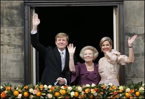 Dutch King Willem-Alexander, Queen Maxima, right, and Princess Beatrix appear on the balcony of the Royal Palace in Amsterdam, The Netherlands today. About a million people are expected to descend on the Dutch capital for a huge street party to celebrate the first new Dutch monarch in 33 years. 