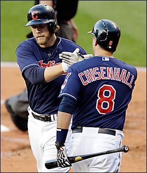 The Indians' Mark Reynolds, left, is congratulated by Lonnie Chisenhall after he hit a homer.