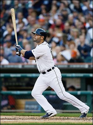Detroit Tigers Alex Avila watches as his solo home run clears the fence during the second inning against the Minnesota Twins in Detroit.