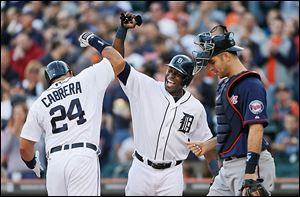 Detroit Tigers' Miguel Cabrera celebrates his two-run home run by teammate Torii Hunter.