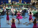  Morgan Shank, 17, center, and her fellow Show Choir Women's Select members perform during Senior Citizens Prom Wednesday evening at Perrysburg High School.