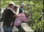  Jerry Gardella, left, and his daughter Emma Gardella, both of Sheffield Lake, look on during last year's The Biggest Week in American Birding event along the boardwalk in the Magee Marsh in Oak Harbor.