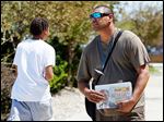  Toledo Streets vendor Moe Gonzalez sells papers near 16th Street and Jefferson Avenue on Wednesday. Toledo Streets is a local paper produced by and for the homeless.