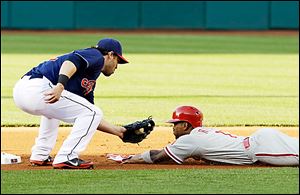 Cleveland's Jason Kipnis tags out Philadelphia's Jimmy Rollins at second base. The Indians have won four consecutive games.