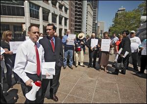 Ohio AFL-CIO President Tim Burga, left, and Tom Enright, a Journeyman Electrician for Romanoff Electric working at Jeep Plant in Toledo, protest proposed Right to Work Legislation.