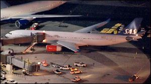 In this image taken from video and provided by television station WNBC-TV, a damaged SAS Airbus A330 sits on the tarmac at Newark Liberty International Airport after clipping the wing of another aircraft on takeoff.